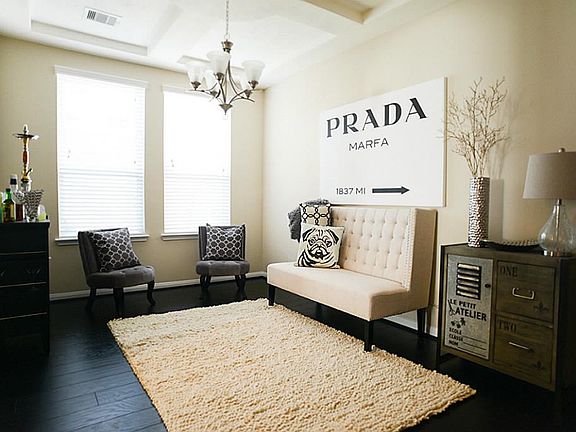 Formal dining room currently used as a sitting area and features upgraded laminate floors, coffered 