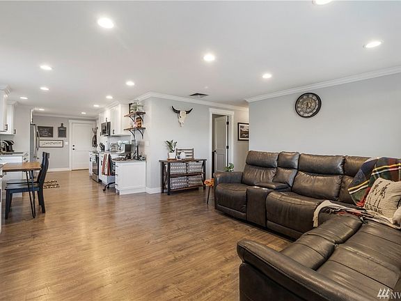 Spacious living room opens to the bright kitchen. Durable flooring, fresh paint and crown molding throughout.