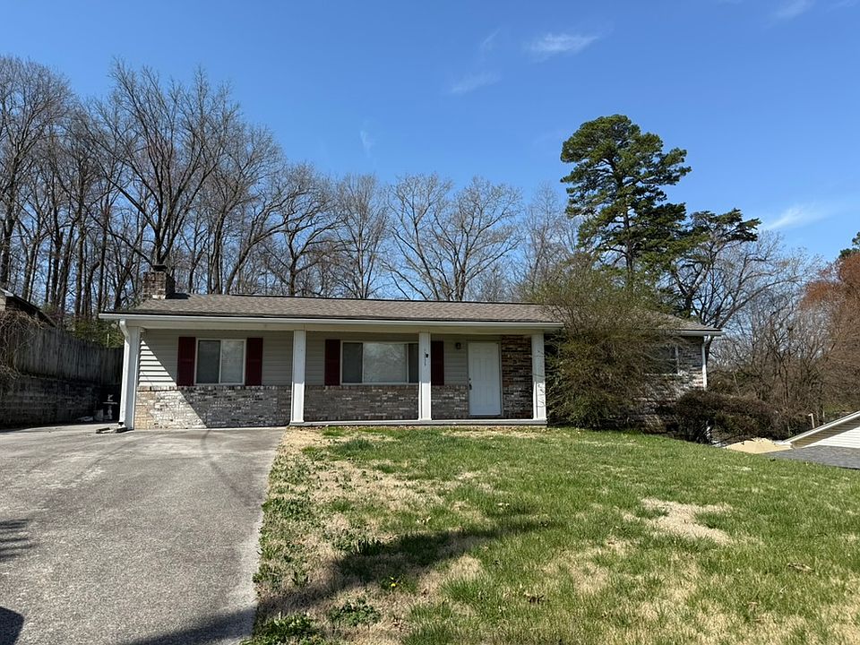 Front of house with huge driveway.