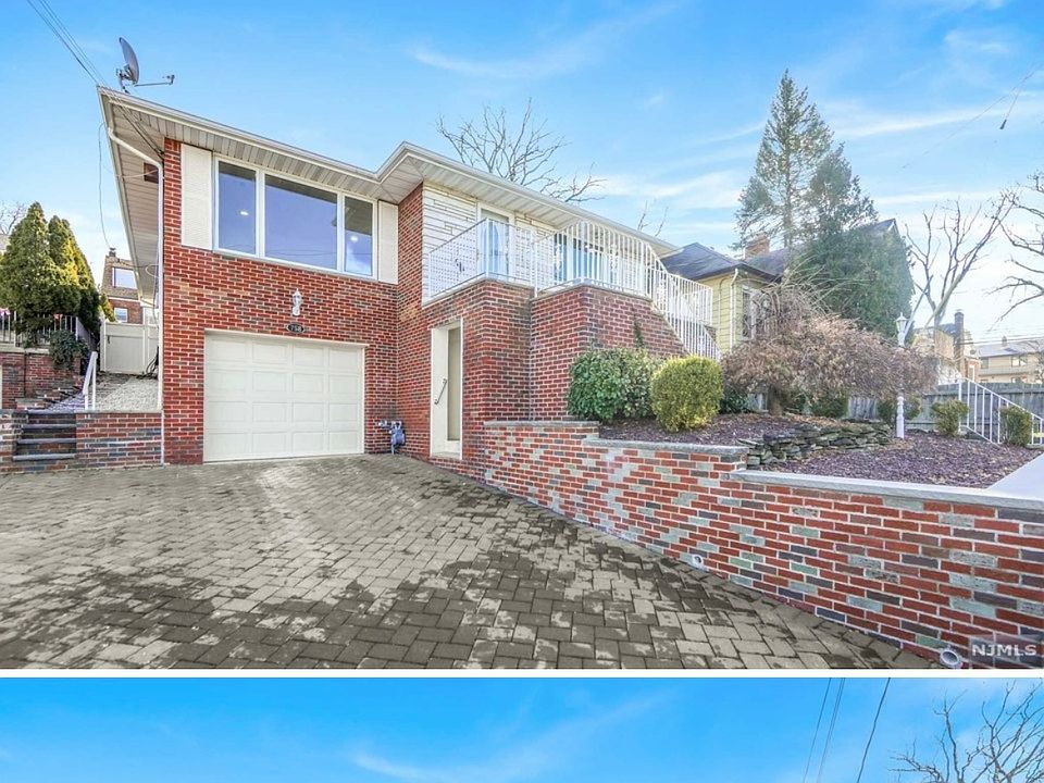 Exterior of home. One entrance upstairs, one downstairs next to garage door.