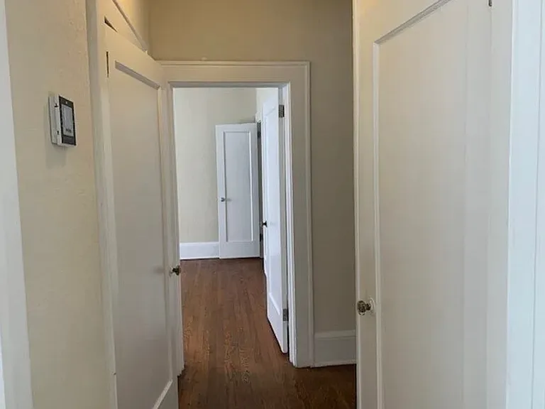 between bedrooms, with bathroom in the middle