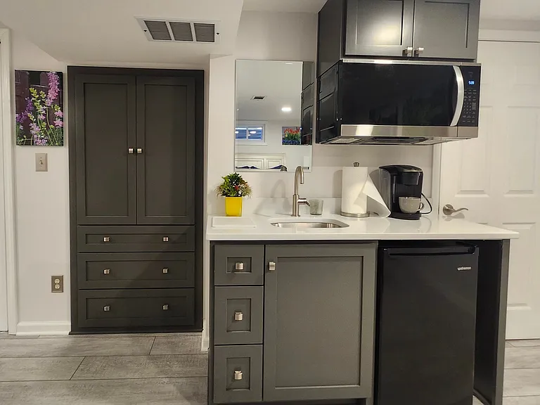Includes dishes, utensils, towels, cutting board, microwave, Keurig coffee maker, mini refrigerator and freezer. Storage side cabinet includes three spacious shelves and 3 very deep drawers