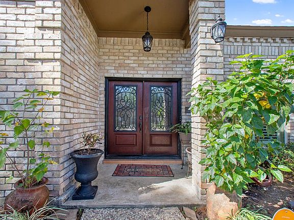 Double front doors have recently been replaced. This beautifully landscaped home features a sprinkler system, gated driveway and updated exterior fixtures