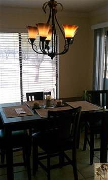 Light and bright dining room has 18" tile floorint and opens