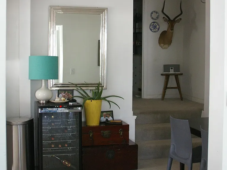 looking south from dining room towards steps up to bathroom and bedroom