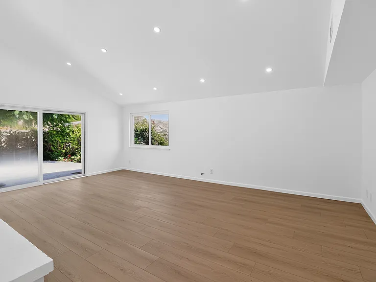 Large living room with sliding doors to backyard.