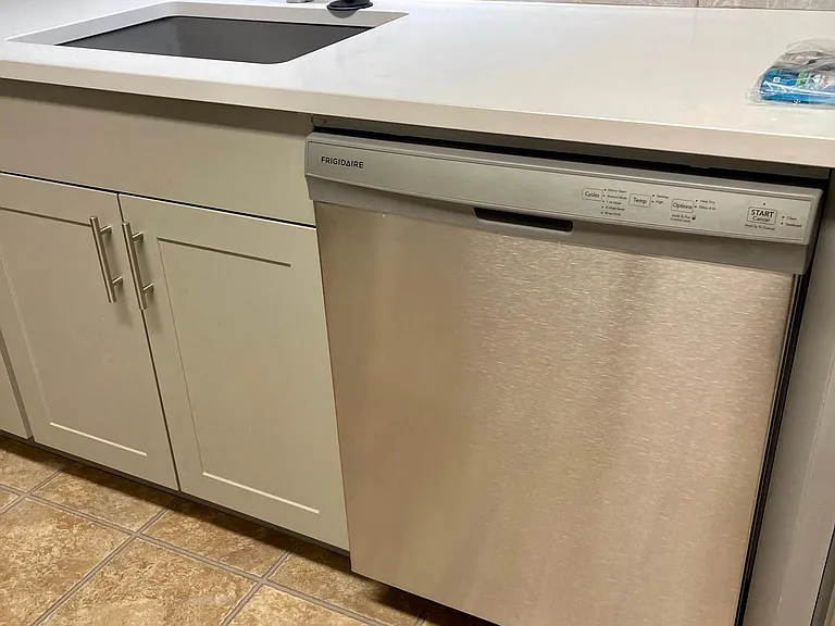 Brand New Stone White Counter, Pull Out Faucet and Stainless Steel Sink. Blue and White tile Backsplash.