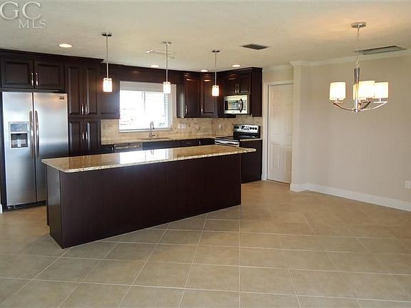 Kitchen with breakfast bar and dining room area 