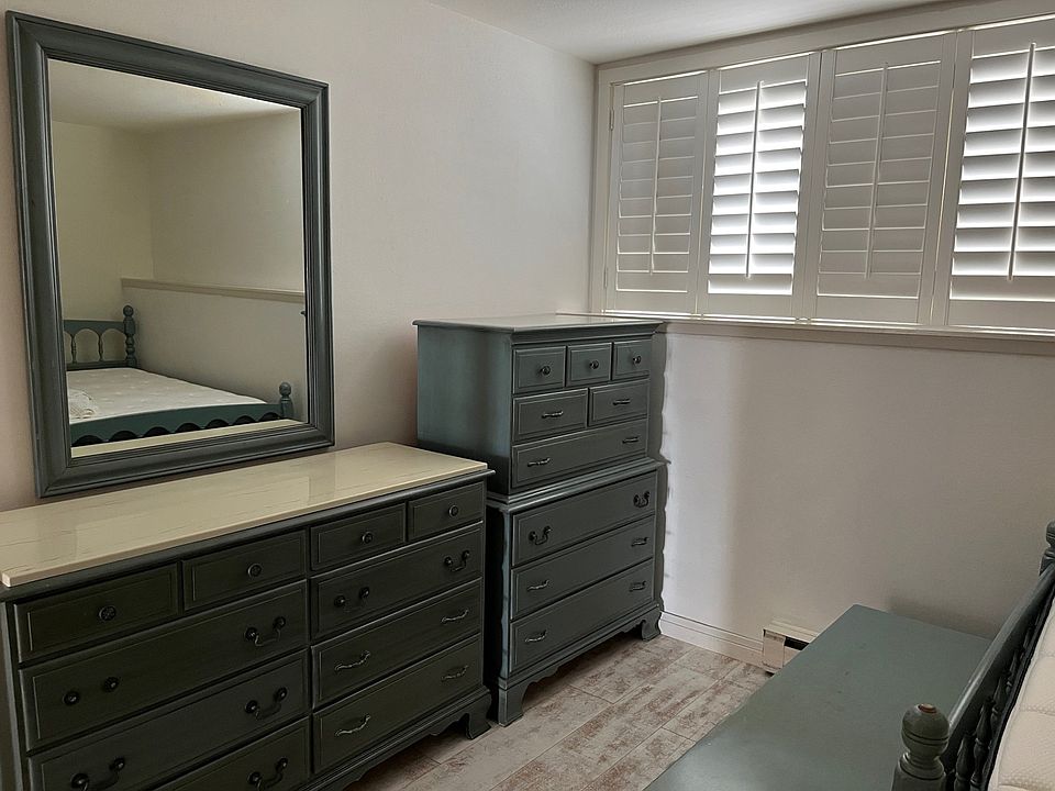 Bedroom 1dressers and east window