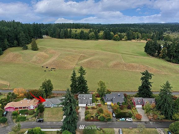 Enjoy the beauty of living across from Langley's Fossek Farm with rolling hills and grazing cows. 