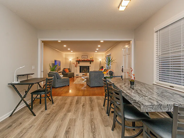 Standing in the kitchen looking at the dining and living room area. Desk area does have a monitor over the desk now.