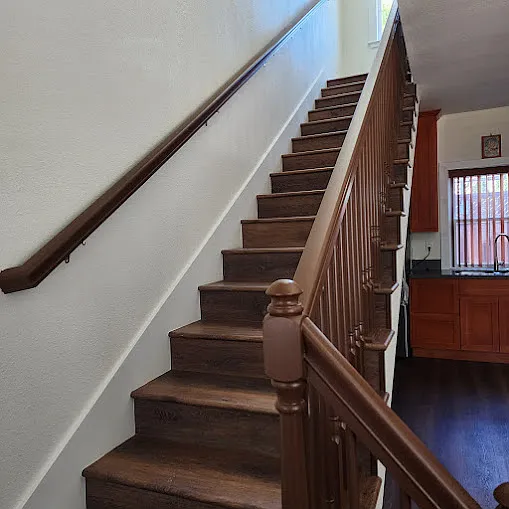 Stairs leading to 2nd story, with space below for mobile kitchen island..