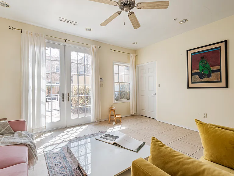 Front entry with French doors opening to a light-filled space.