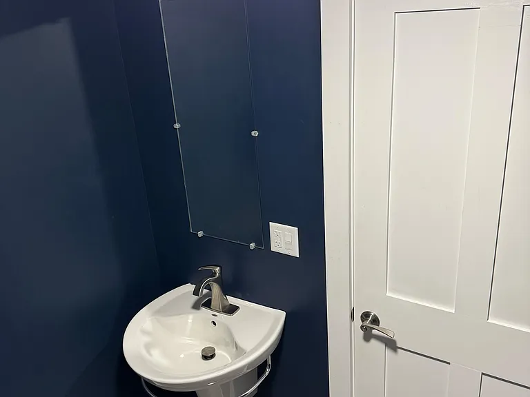 View of the sink in the downstairs half bath.