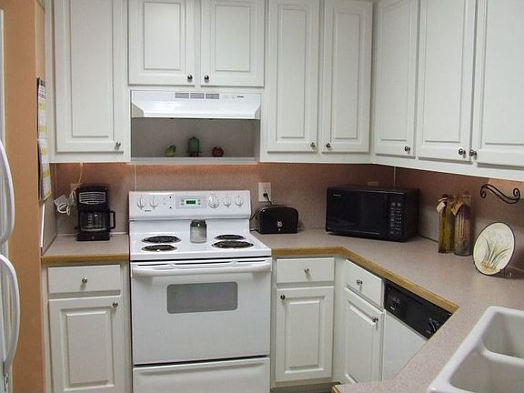 Kitchen features include tile backsplash and updated double sink