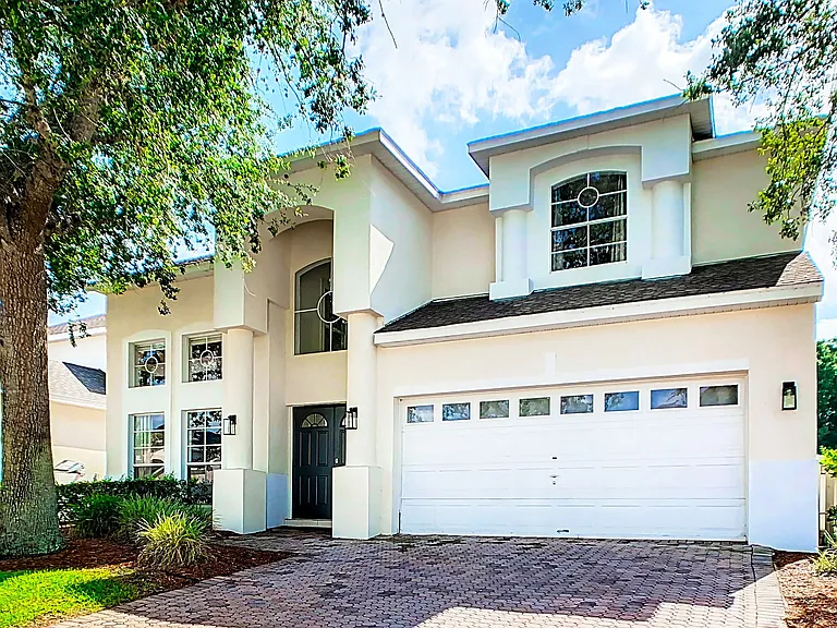 Behold the magnificent exterior of our DisneyEstate! The backyard offers stunning views of your private pool, championship golf course, and resort clubhouse with incredible amenities like Lap Pool, Pickleball, Tennis, and Children's Playground.