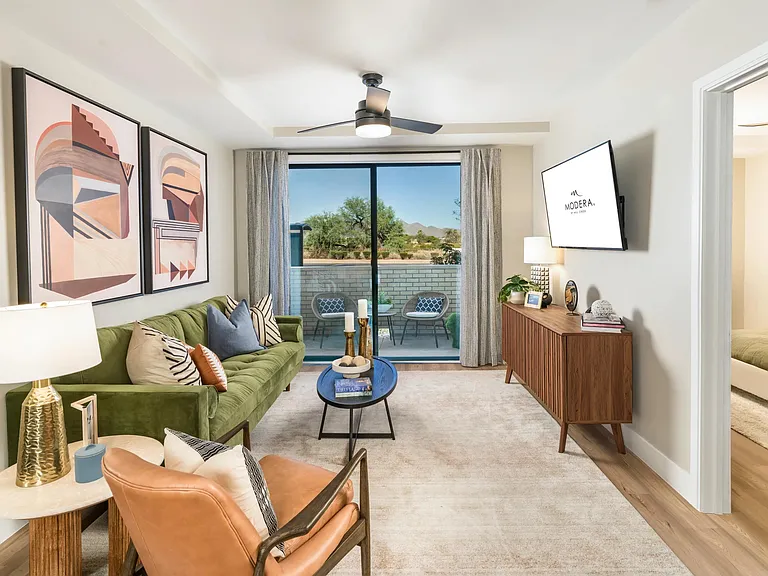 A bright and inviting living space designed for comfort and connection, featuring stylish finishes and a private patio that invites the outdoors in.