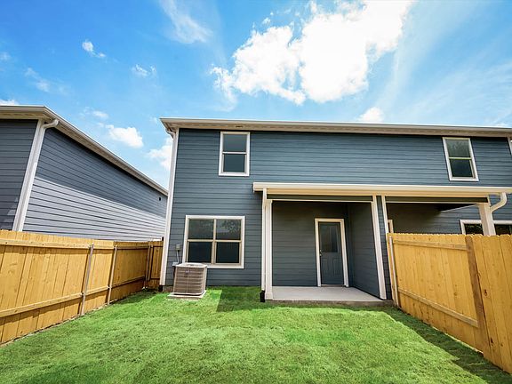 Covered back patio and a fenced-in back yard