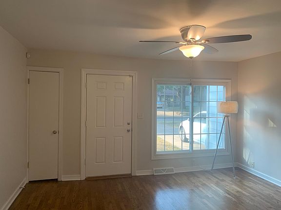 Light bright living room newly painted with designer light gray paint and newer nickel ceiling fan. Coat closet and nickel door knobs all through the home.