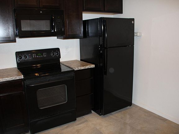 Newly remodeled kitchen with new cabinets, countertops and tile floors. Appliances included: Dishwasher, refrigerator, garbage disposal, and over the range microwave. Range pictured will be replaced December 2019. This could also be a dine-in kitchen with