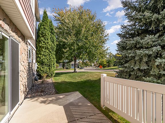 Patio with privacy fence and evergreen trees.