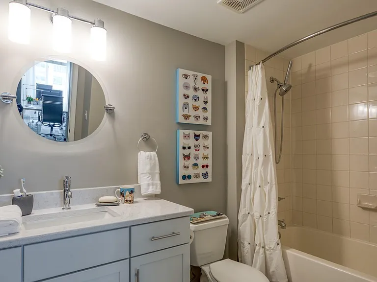 The beautiful skaker-style cabinetry and quartz countertops follow from your kitchen into your relaxing bathroom space!