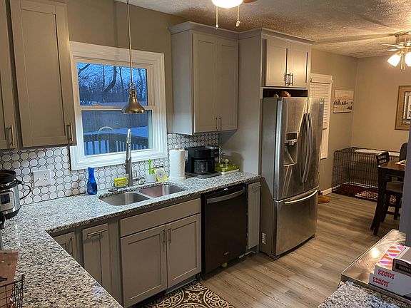 The newly-remodeled kitchen includes a refrigerator, stove, oven and dishwasher.