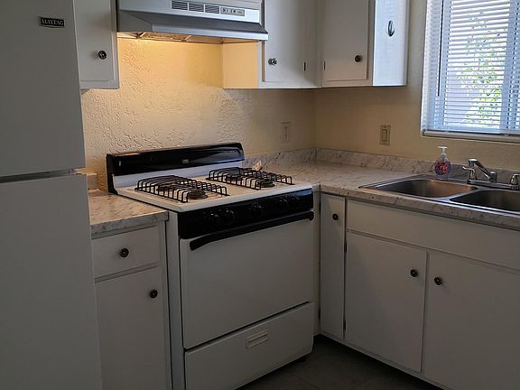 Kitchen with new floor tile and new counter top.