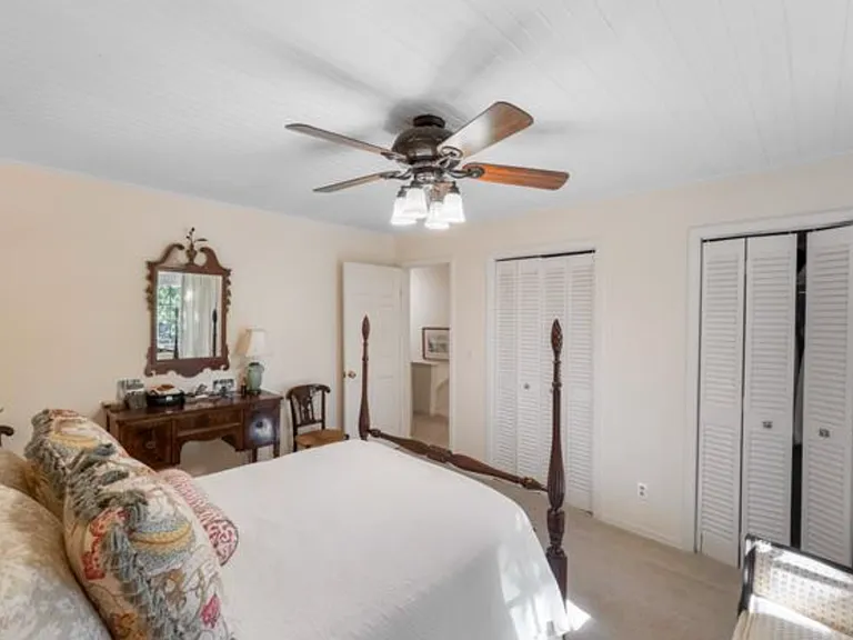 Top floor bedroom with French doors to private balcony.