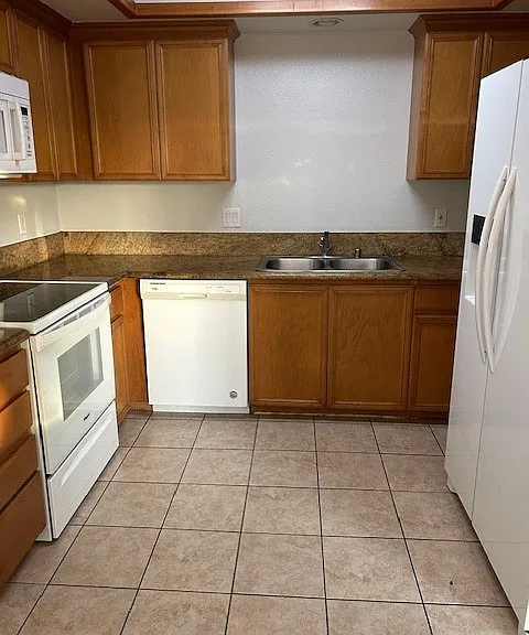 Kitchen with granite and new appliances.