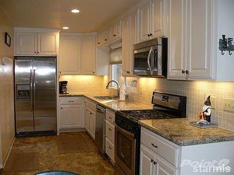 Completely remodeled kitchen with tile backsplash, stainless steel appliances, sink and faucet.  The stove provides gas cooking and baking and the granite counters offer plenty of space for food preparation; not to mention the ease of cleaning!