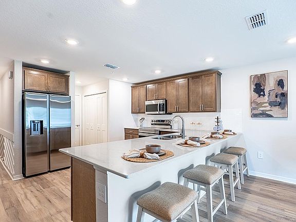 Your beautiful kitchen includes quartz and high-end finishes, along with ample cabinet space and a p
