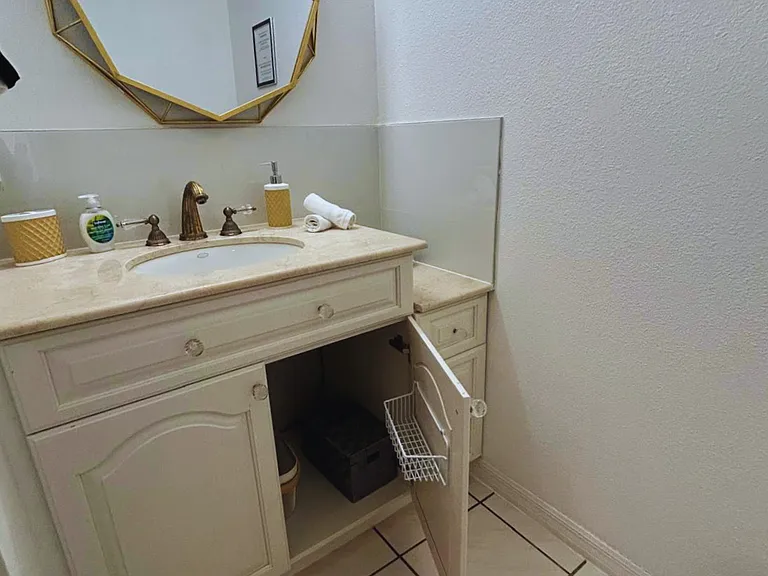 Elegant bathroom vanity with modern sink, stylish mirror, and beautiful finishes.