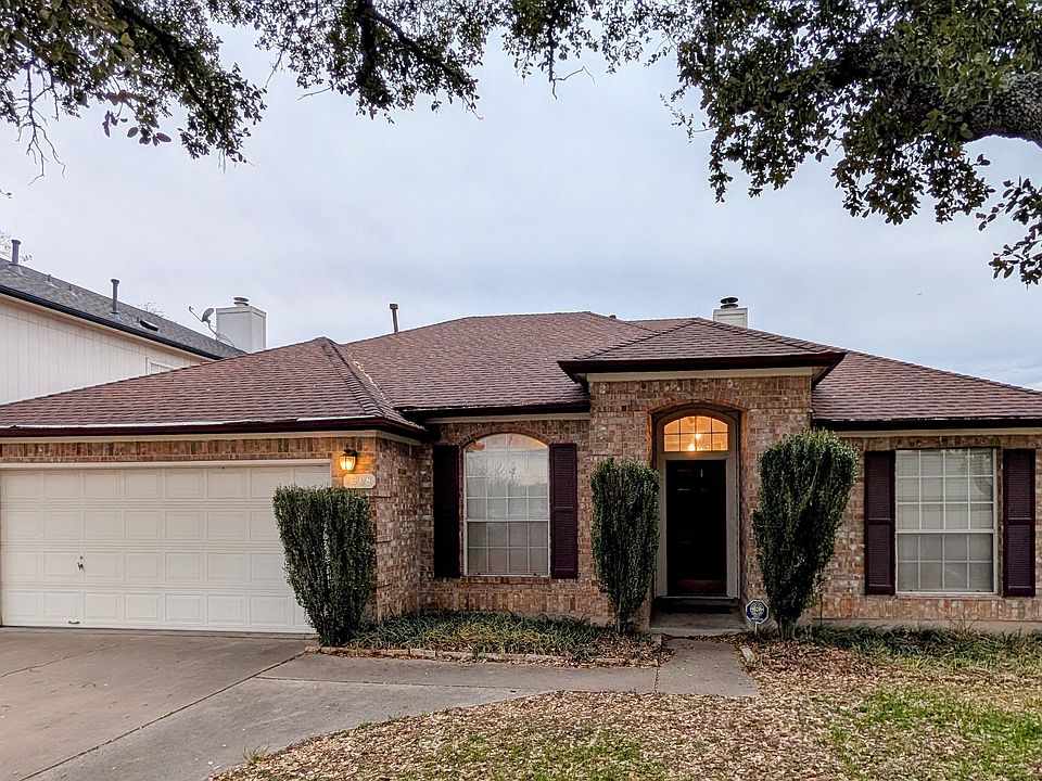 View from the sidewalk. ~7 beautiful live oaks in the front yard. Extra wide driveway.