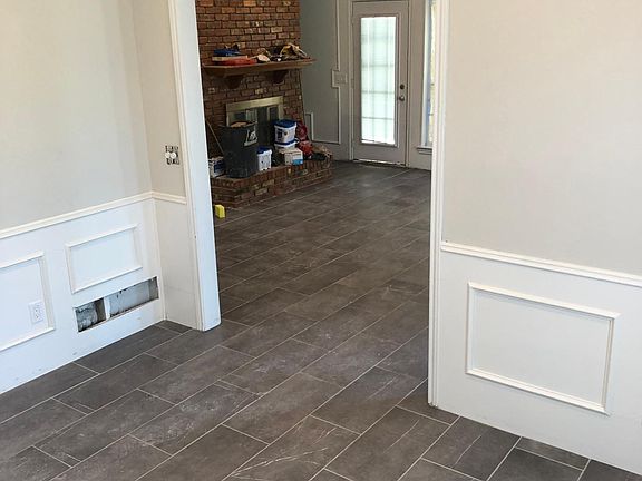 Downstairs dining room, living room, and bedroom have large format ceramic flooring for beauty and ease of maintenance,