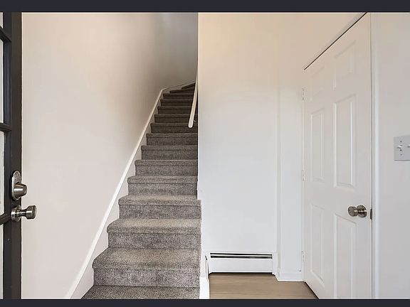 Stairs up to bright and sunny unit. Storage closet to the right