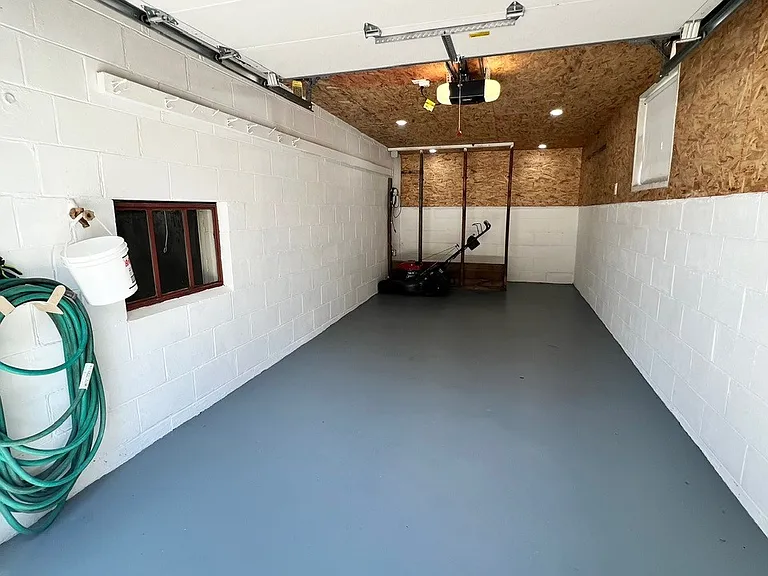 Extra deep single car garage with hose hook-up and extra space for storage. Private entry from back of garage into house.