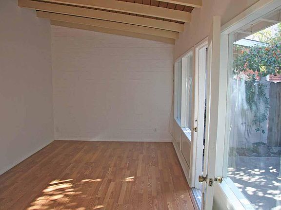 Wall of Windows view to back yard. Open beam / high ceiling