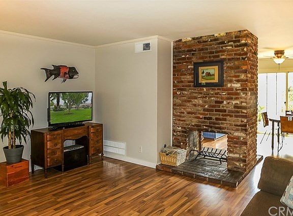 Living room, looking towards kitchen/eating area and back yard