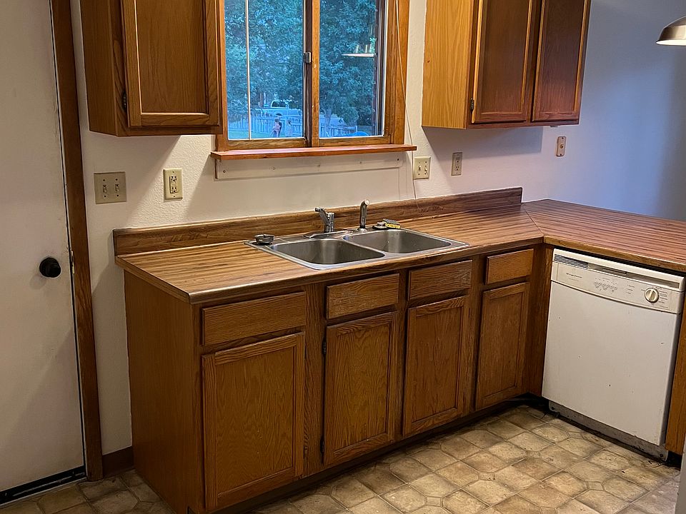Kitchen with ample cabinet space and a door to a side porch