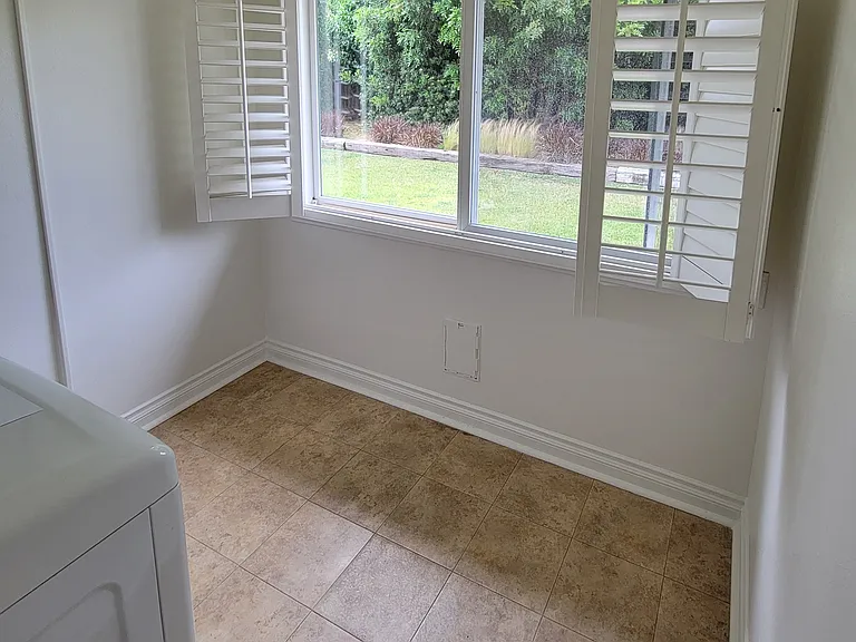Laundry room with window into backyard. Storage too.