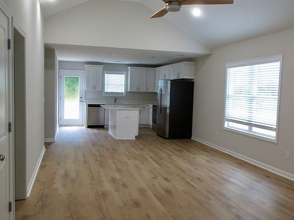 Entrance to living & dining rooms with recessed lighting, fan & vaulted ceilings