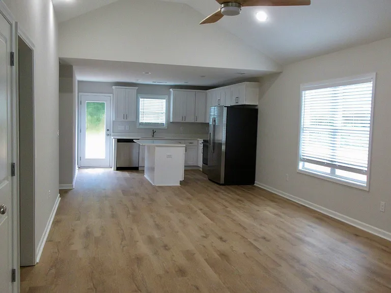 Entrance to living & dining rooms with recessed lighting, fan & vaulted ceilings