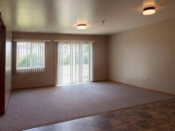 Spacious living area walks out onto a patio.