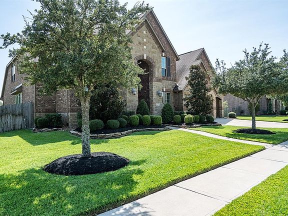 Mature trees and lush landscaping provides great curb appeal on this over 15,000 sq ft corner lot!