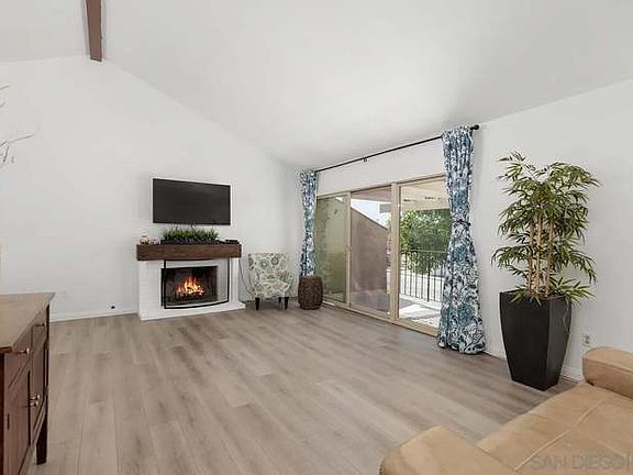 Living room with fireplace and outdoor patio seating area