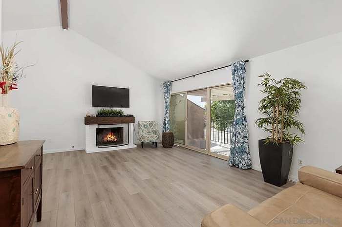 Living room with fireplace and outdoor patio seating area