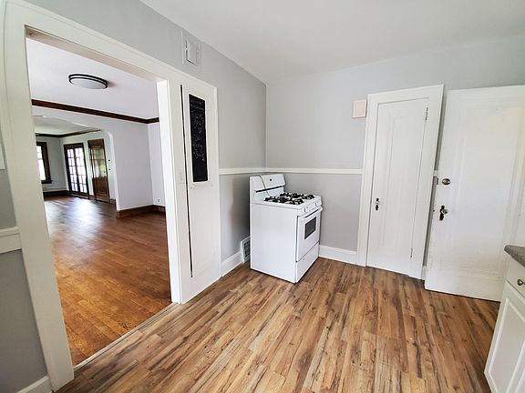 Kitchen: Stove, pantry, chalk board, spice cabinet. entry to dining room/living room