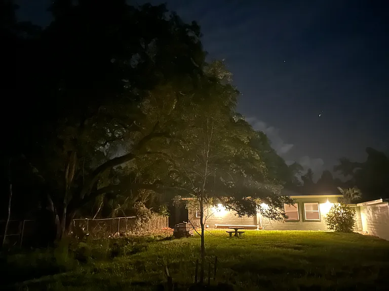 From the Waterside, the view of the Home during evening hours with the outdoor lights.