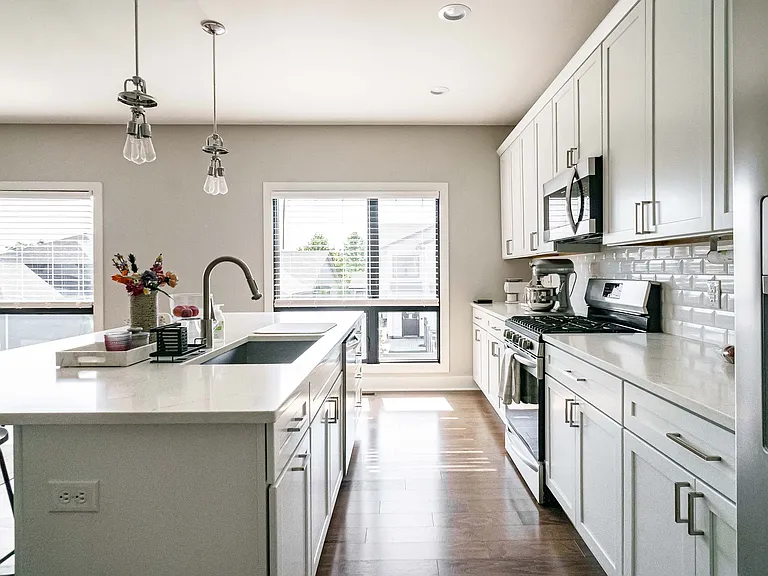 Kitchen with stainless steel appliances, island, and cabinetry